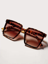 This pair of leopard-print sunglasses combines stylish design with practical protection by fashioncafee.com